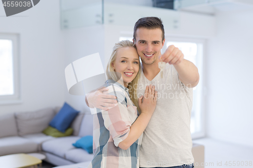 Image of couple showing a keys of their new house