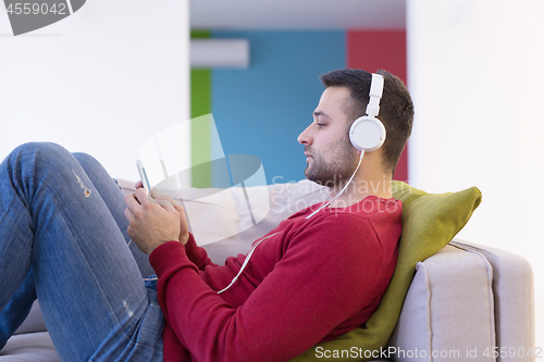 Image of man enjoying music through headphones