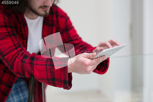 Image of young freelancer using tablet computer