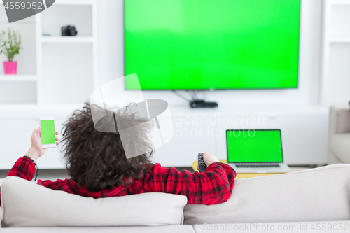 Image of young man in bathrobe enjoying free time