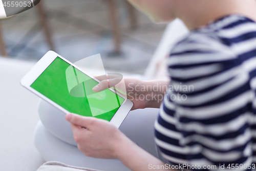 Image of woman on sofa using tablet computer