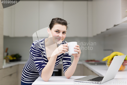Image of woman drinking coffee enjoying relaxing lifestyle