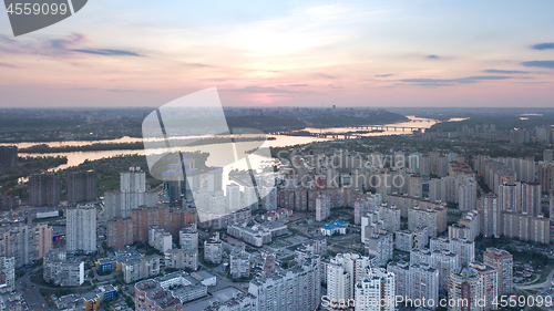 Image of A bird\'s eye view, aerial panoramic view from drone to the Darnyts\'kyi district of Kiev, Ukraine and view to the right bank of Dnieper at sunset in the summer.