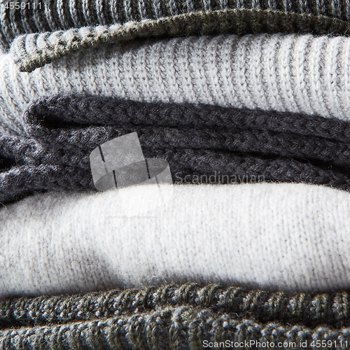 Image of stack of warm winter knitted sweaters