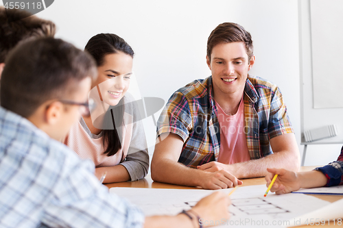 Image of group of smiling students with blueprint