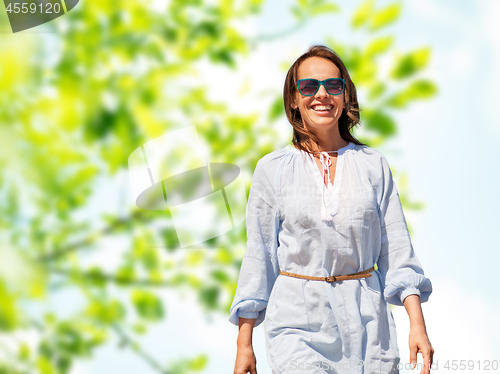 Image of happy smiling woman over green natural background