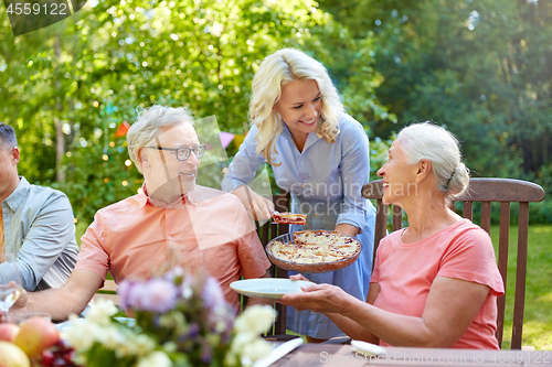 Image of happy family having dinner or summer garden party