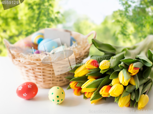 Image of close up of colored easter eggs and tulip flowers