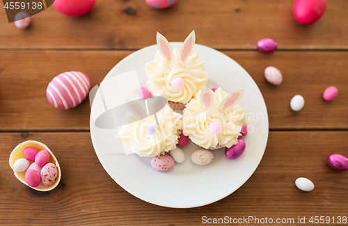 Image of cupcakes with easter eggs and candies on table