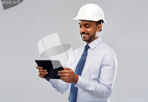 Image of architect or businessman in helmet with tablet pc