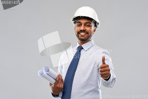 Image of architect or businessman in helmet shows thumbs up