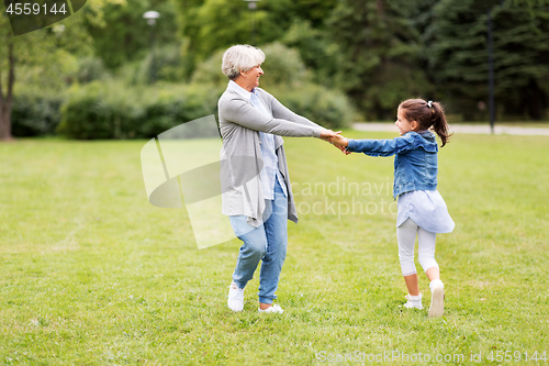 Image of grandmother and granddaughter playing at park