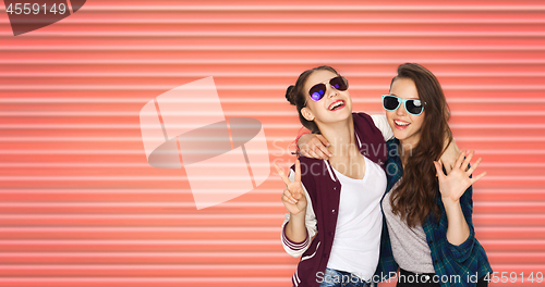 Image of happy teenage girls in sunglasses showing peace