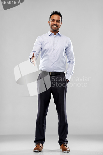 Image of indian businessman stretching hand for handshake