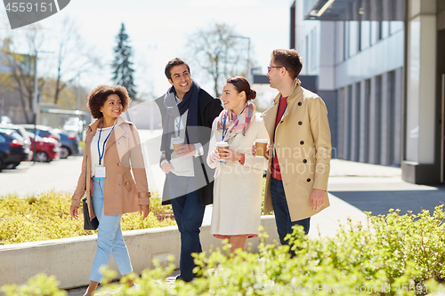 Image of office workers with coffee on city street