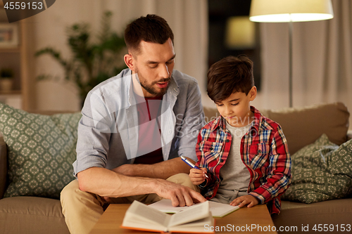 Image of father and son doing homework together