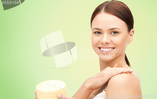 Image of beautiful woman with moisturizing cream