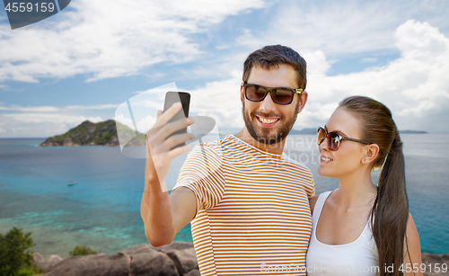 Image of couple taking selfie by smartphone on seychelles