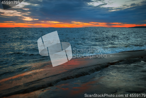 Image of Orange Sunset Over a Stormy Lake 