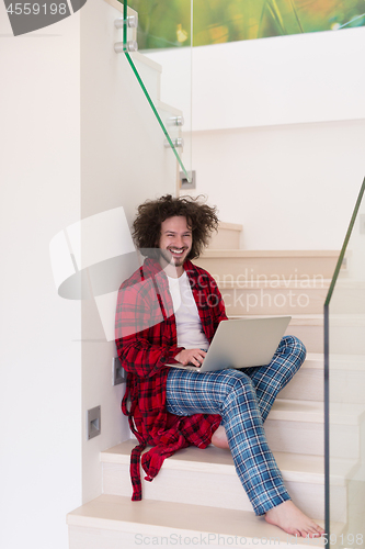 Image of freelancer in bathrobe working from home