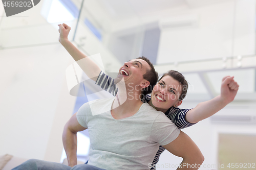 Image of handsome man piggybacking his girlfriend