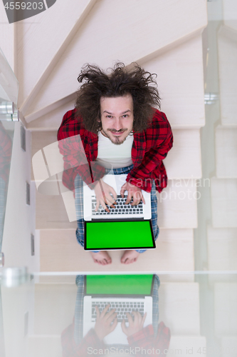 Image of freelancer in bathrobe working from home