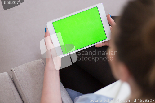 Image of woman on sofa using tablet computer