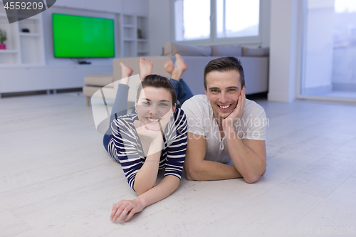 Image of couple lying on the floor at home