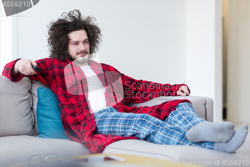 Image of young man in bathrobe enjoying free time