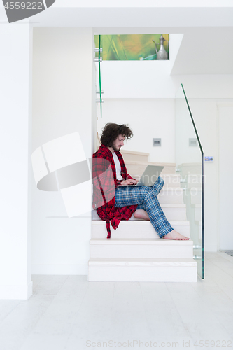 Image of freelancer in bathrobe working from home