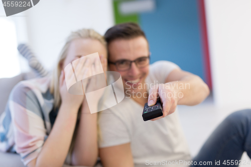 Image of Young couple on the sofa watching television