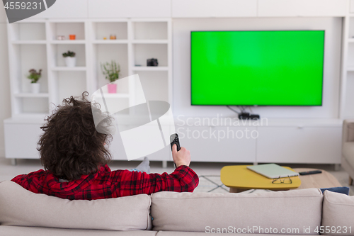 Image of young man in bathrobe enjoying free time