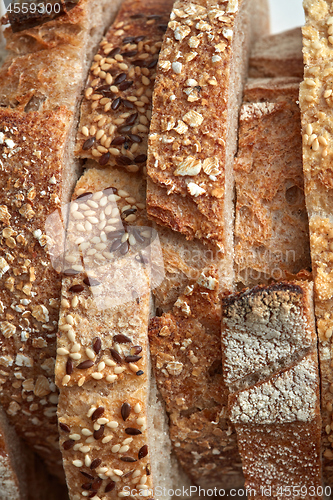 Image of Macro photos of slices of homemade, grain bread with sesame seeds and flax. Organic Healthy Food. Flat lay