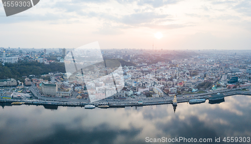 Image of The panoramic bird\'s eye view shooting from drone of the Podol district, the right bank of the Dnieper River and centre of Kiev, Ukraine at summer sunset on the background of the cloudy sky.