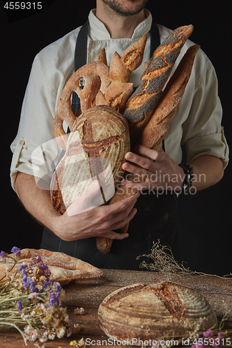 Image of Variety of bread hold men\'s hands