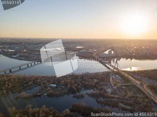 Image of Bridge over the Dnieper River at sunset, the city of Kiev in the distance