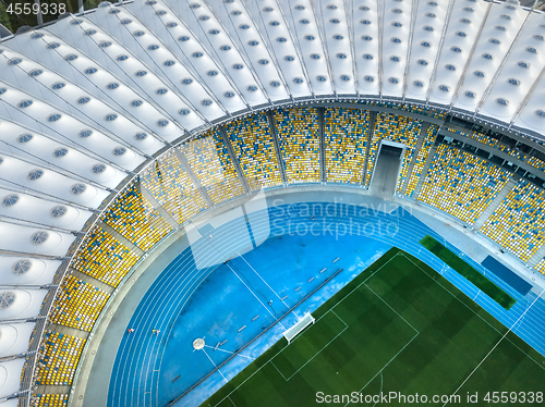 Image of KYIV, UKRAINE - July 19, 2018. National Sports Complex Olympic NSC Olimpiysky. Aerial view from drone of construction of the stadium cover, green football field, tribunes.