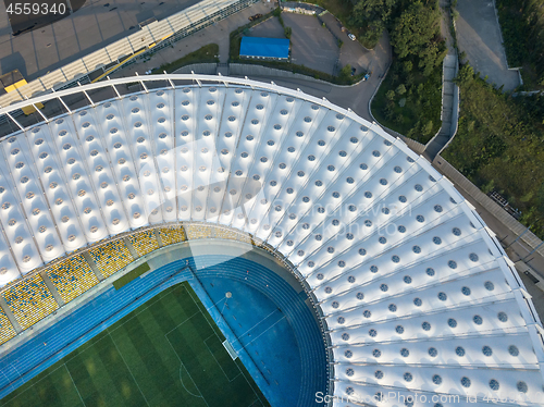 Image of KYIV, UKRAINE - July 19, 2018. Panoramic view from drone of construction the stadium roof, green football field, tribunes of National Sports Complex Olympic.