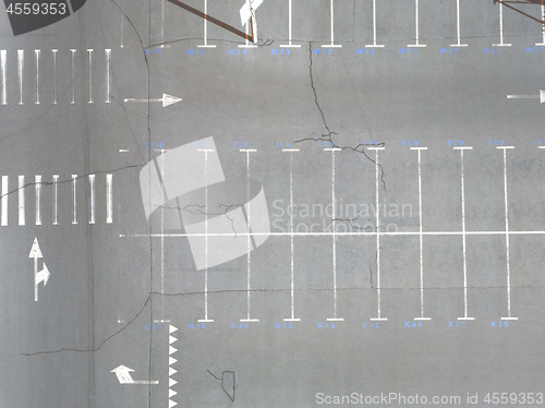 Image of Aerial view of many empty parking spaces with markings summer day . Top view