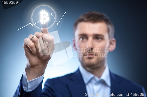 Image of hand man Icon Bitcoin on virtual screen.