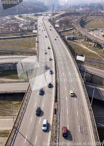 Image of Aerial view from drone traffic overpass with moving cars on an asphalt road in a sunny day Kiev, Ukraine.