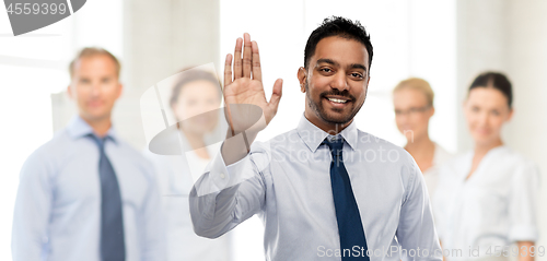 Image of indian businessman making high five gesture