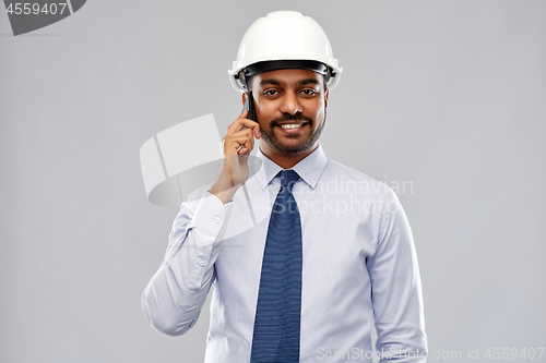 Image of indian architect in helmet calling on smartphone