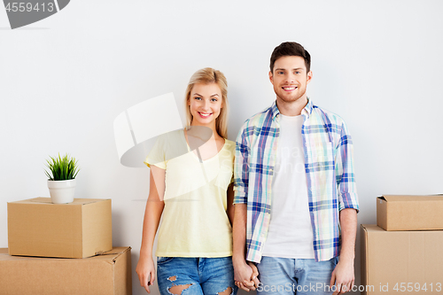 Image of happy couple with boxes moving to new home