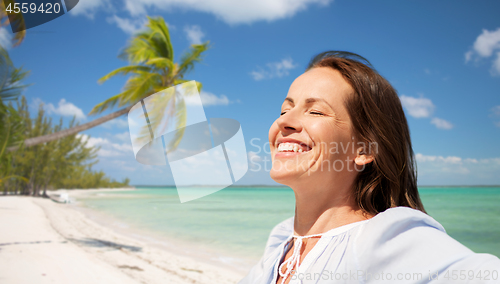 Image of happy woman over tropical beach background