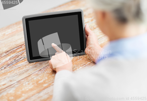 Image of senior woman with black screen on tablet computer