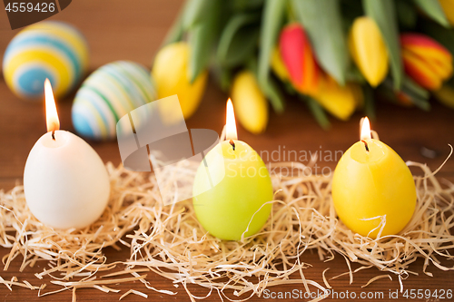 Image of candles in shape of easter eggs and tulip flowers