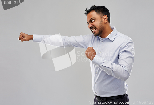 Image of angry indian businessman fighting over grey