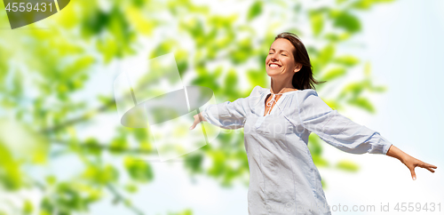 Image of happy smiling woman over green natural background