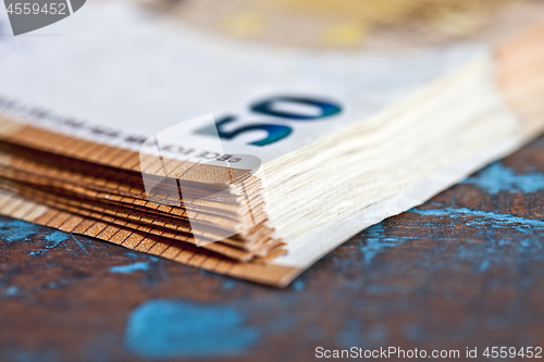 Image of Currency bank notes stacked on rustic wooden table background cl